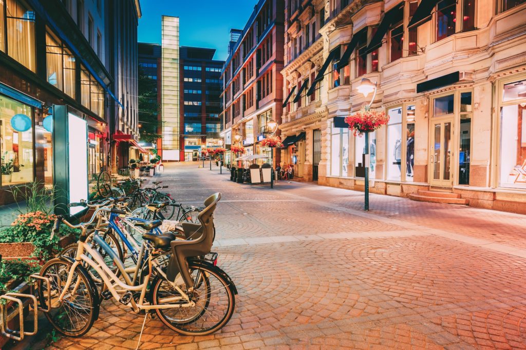 Helsinki, Finland. Bicycles Parked Near Storefronts In Kluuvikat